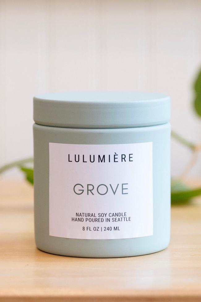 Light pastel purple metal candle with lid showing Earl Grey scent and modern simple branding. 